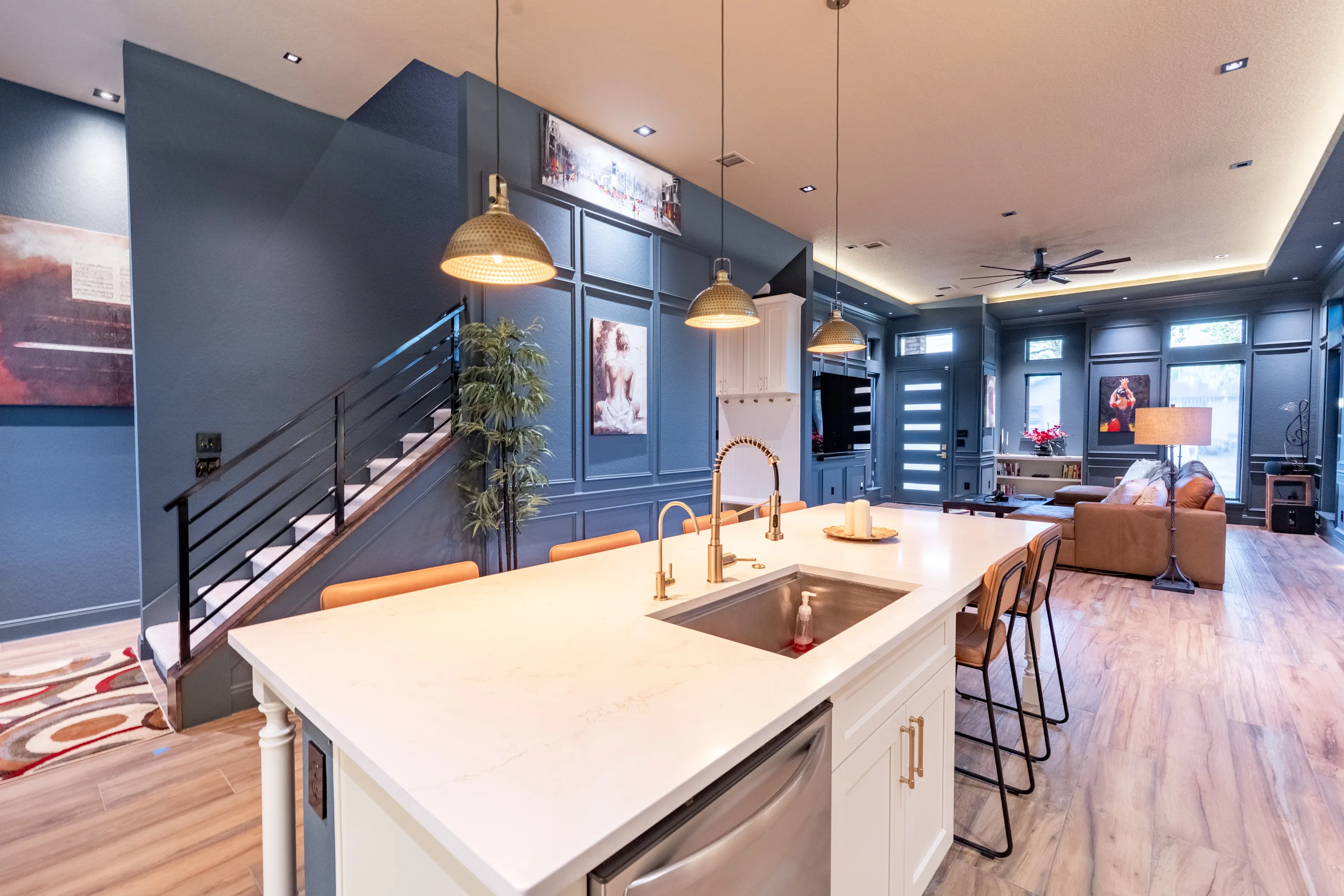 Open-concept great room and kitchen in an Ella Bree custom home, with vaulted wood ceilings.
