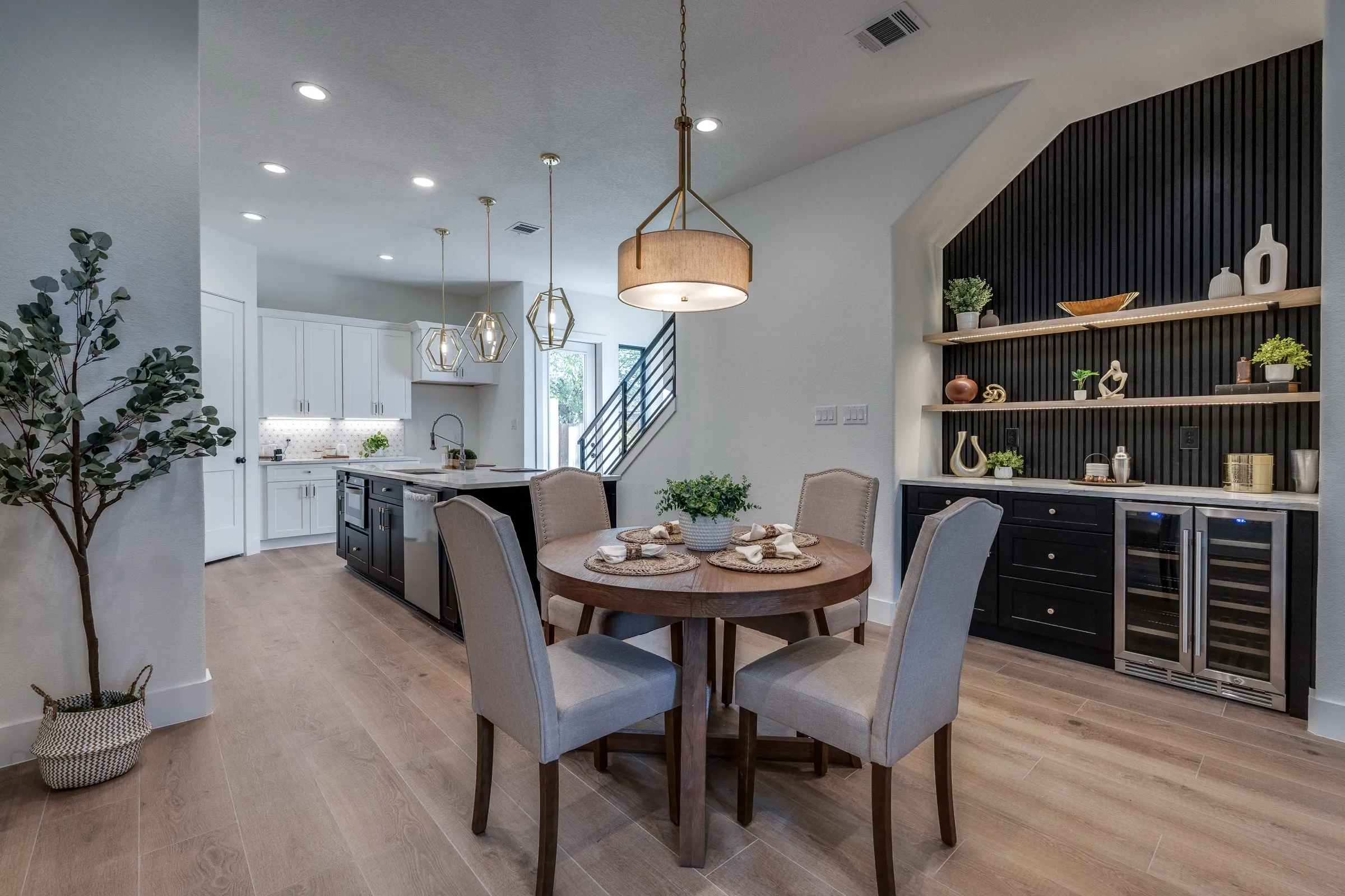 Interior of an Ella Bree home: open dining and kitchen with vintage shelving.